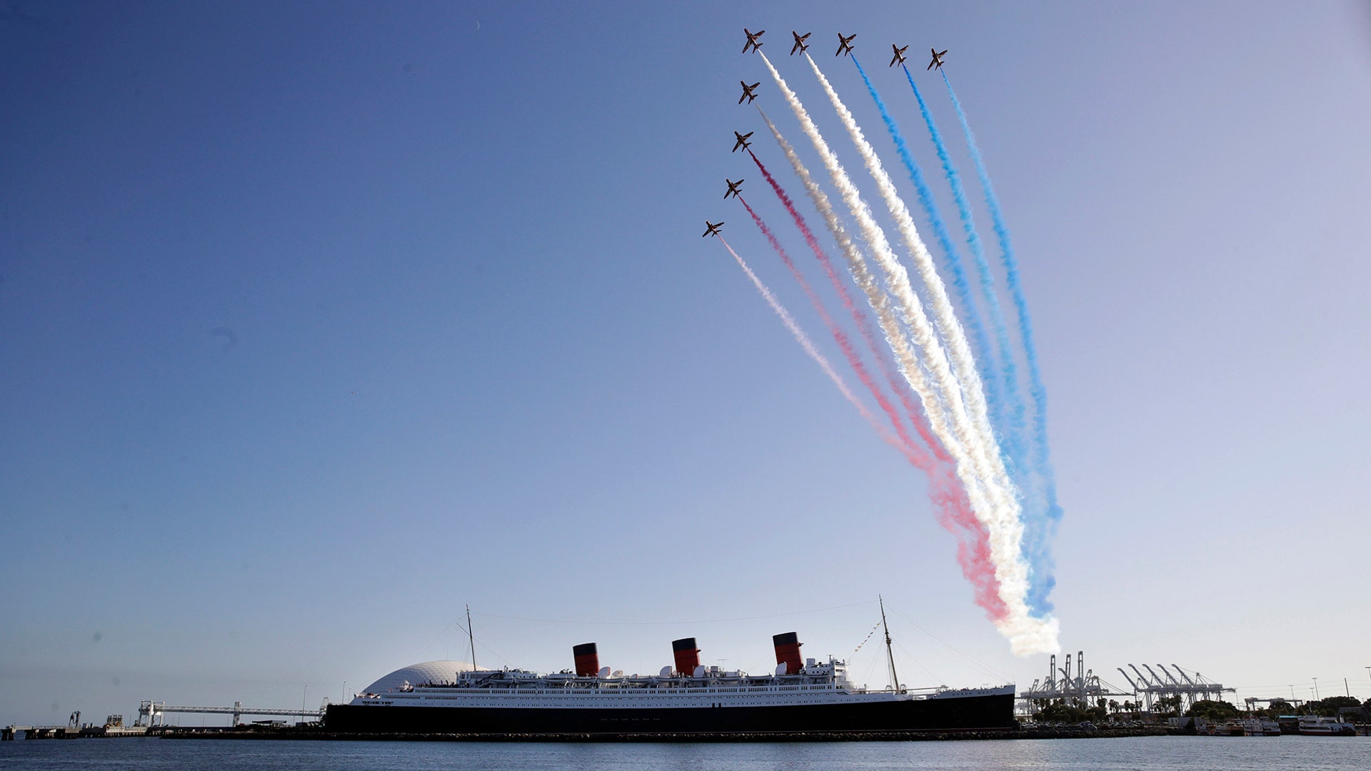 The Red Arrows, the British Royal Air Force aerobatic team, fly in formation over the historic Queen Mary ocean liner in Long Beach, California, Oct. 2, 2019. 