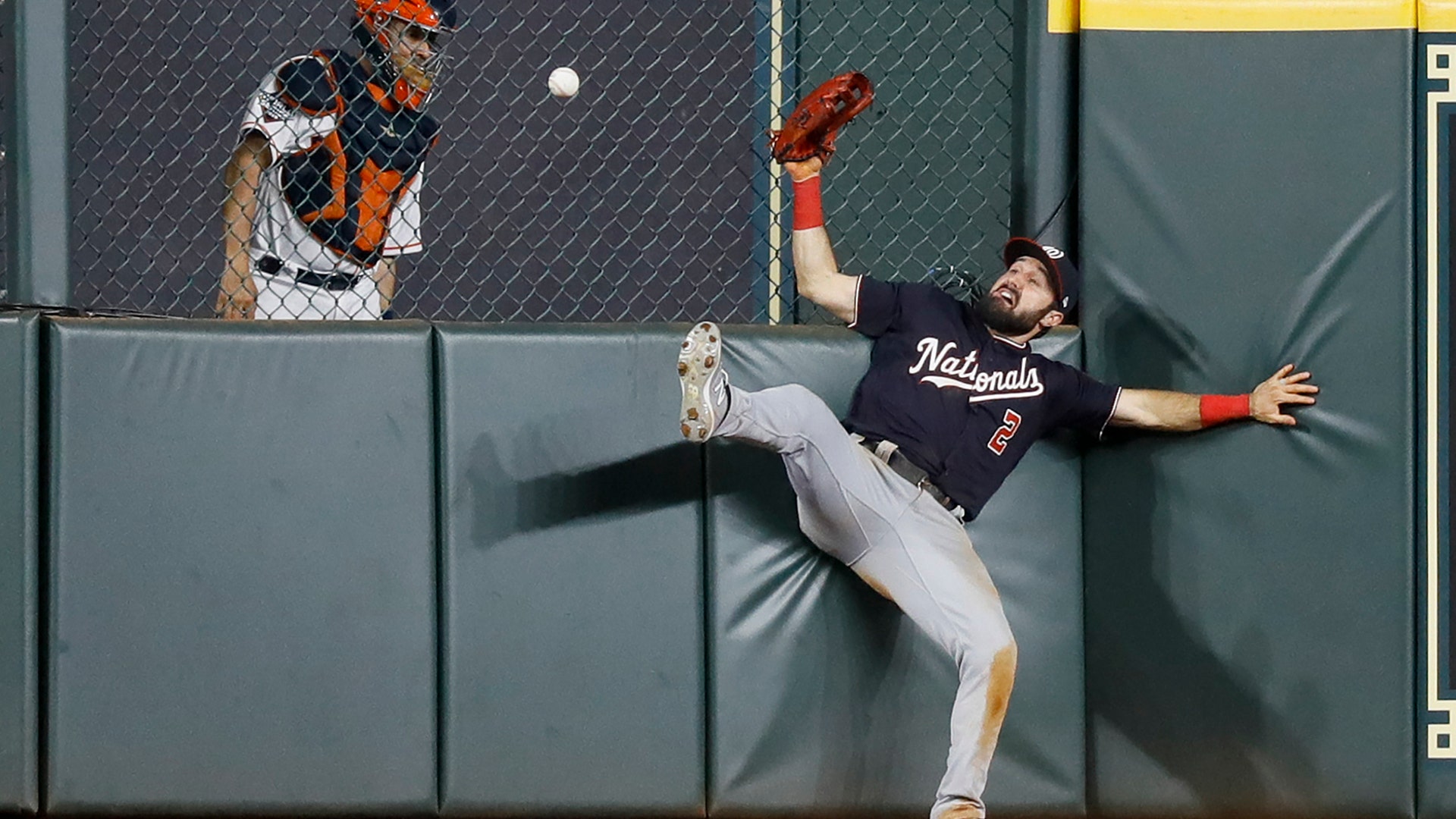 Washington Nationals right fielder Adam Eaton can't get a glove on an RBI-double by Houston Astros' George Springer during the eighth inning of Game 1 of the World Series in Houston, Oct. 22, 2019. 