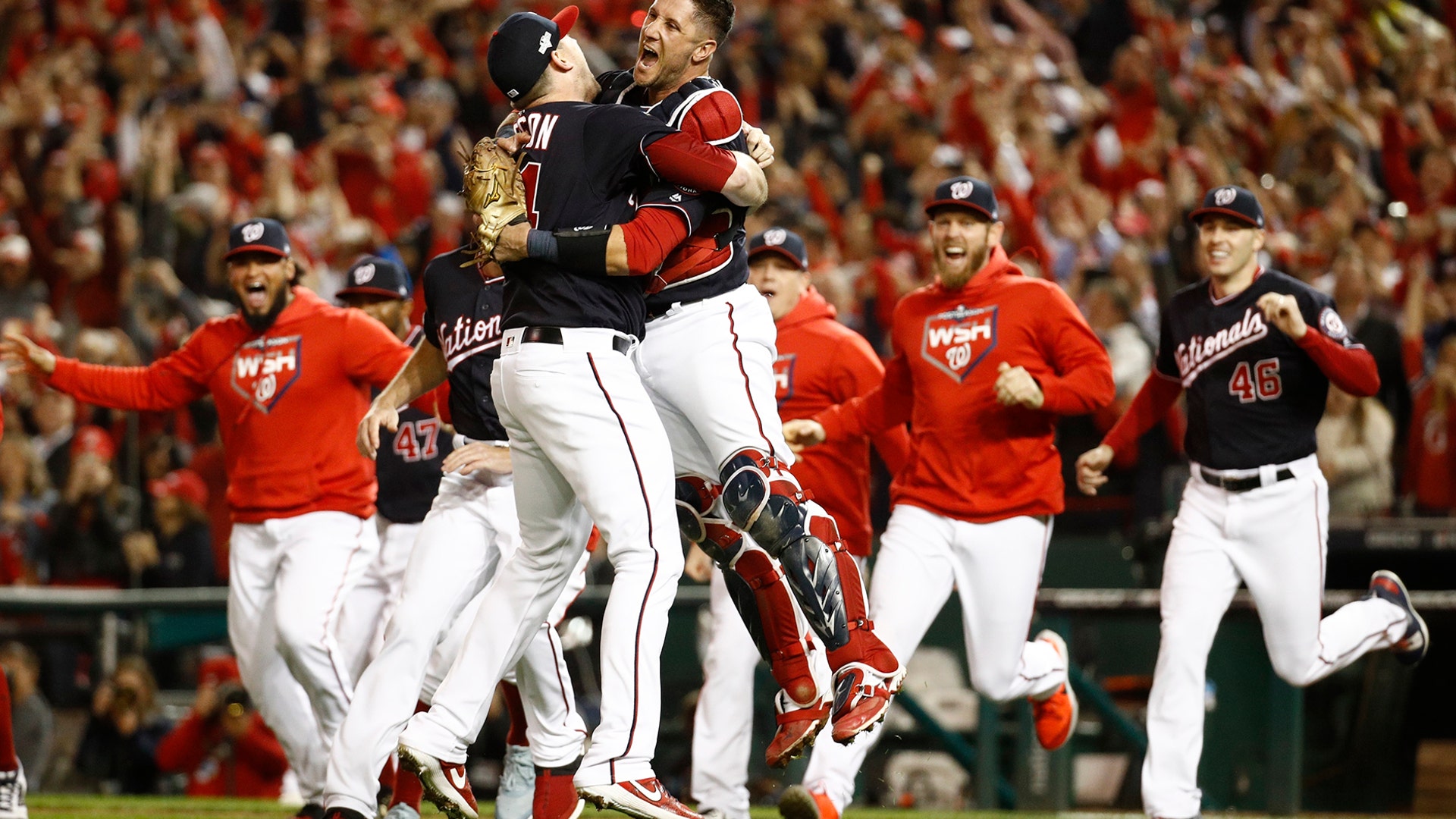 Washington Nationals' Yan Gomes and Daniel Hudson celebrate advancing to the World Series after defeating the St. Louis Cardinals in the National League Championship Series in Washington, Oct. 15, 2019.