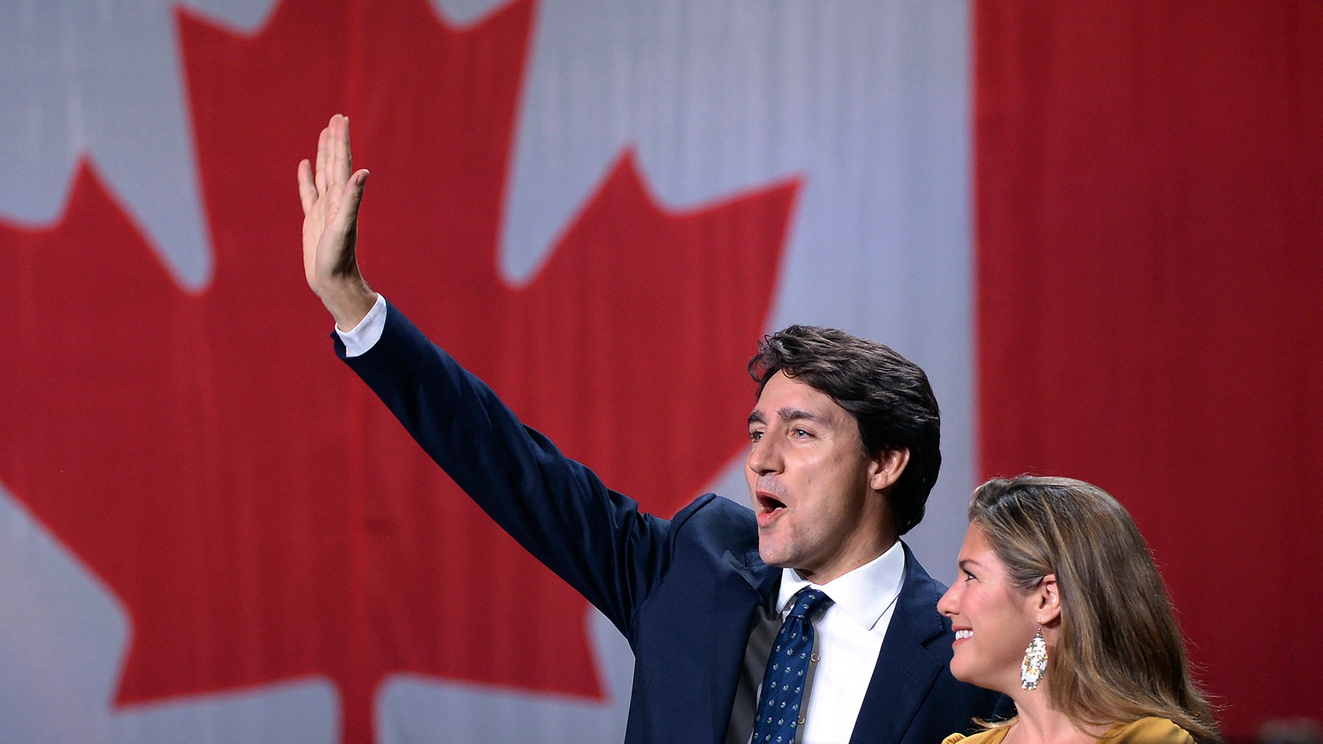 Liberal leader Justin Trudeau and wife Sophie Gregoire Trudeau wave after the Liberals won a minority government in Canada's general election in Montreal, Oct. 21, 2019.