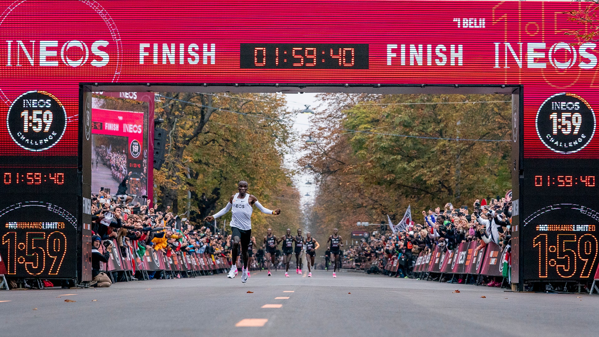 Eliud Kipchoge celebrates as he crosses the finish line to become the first person to run a marathon in under 2 hours in Vienna, Oct.12, 2019.