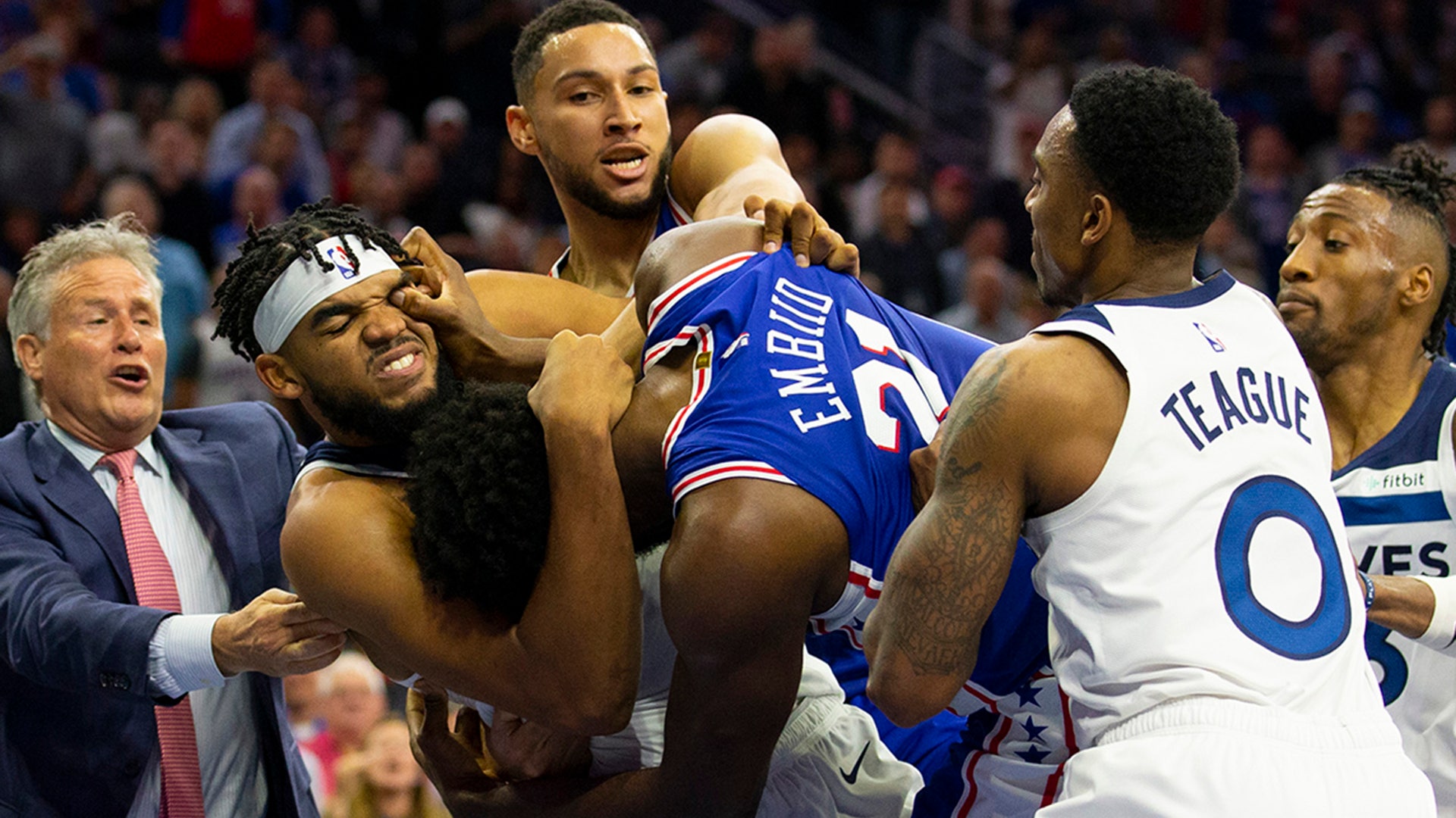 Joel Embiid of the Philadelphia 76ers fights with Karl-Anthony Towns of the Minnesota Timberwolves in the third quarter of their NBA game in Philadelphia, Oct. 30, 2019. 