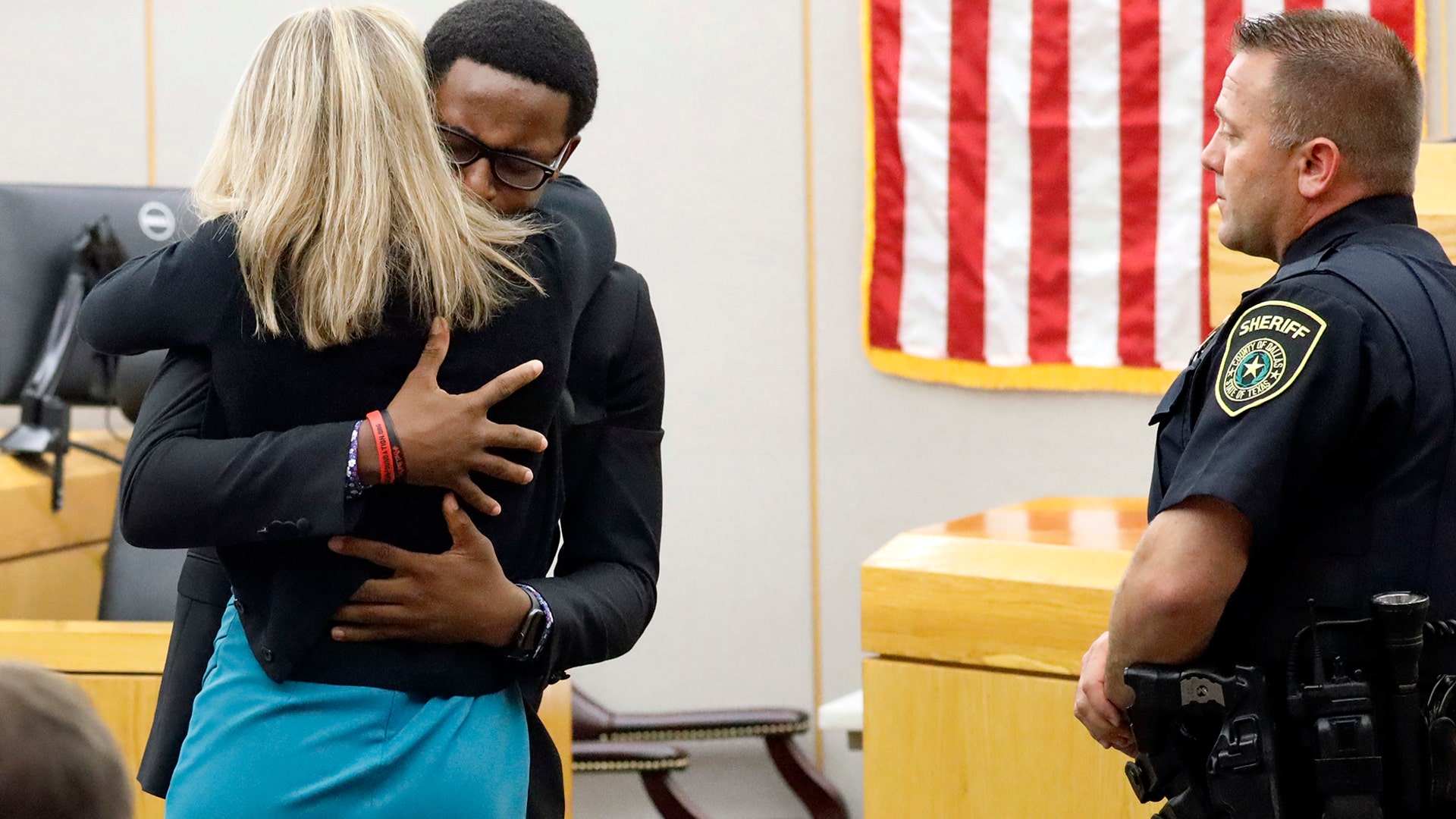 Botham Jean's younger brother, Brandt Jean, hugs convicted murderer and former Dallas Police Officer Amber Guyger after delivering a statement to her after she was sentenced to 10 years in jail in Dallas, Oct. 2, 2019. 