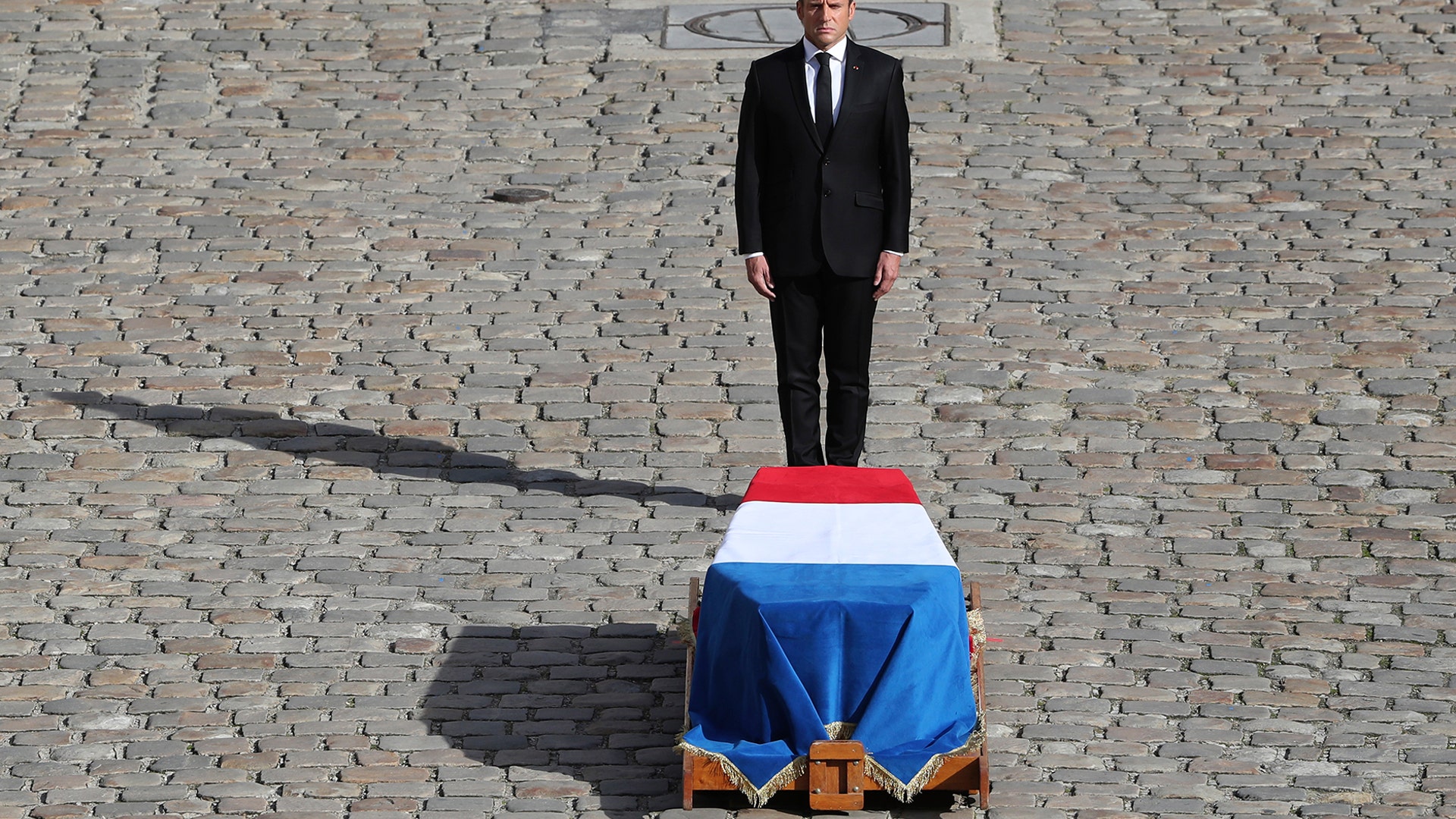 French President Emmanuel Macron pays his respect to former French President Jacques Chirac at Invalides monument in Paris, Sept. 30, 2019.