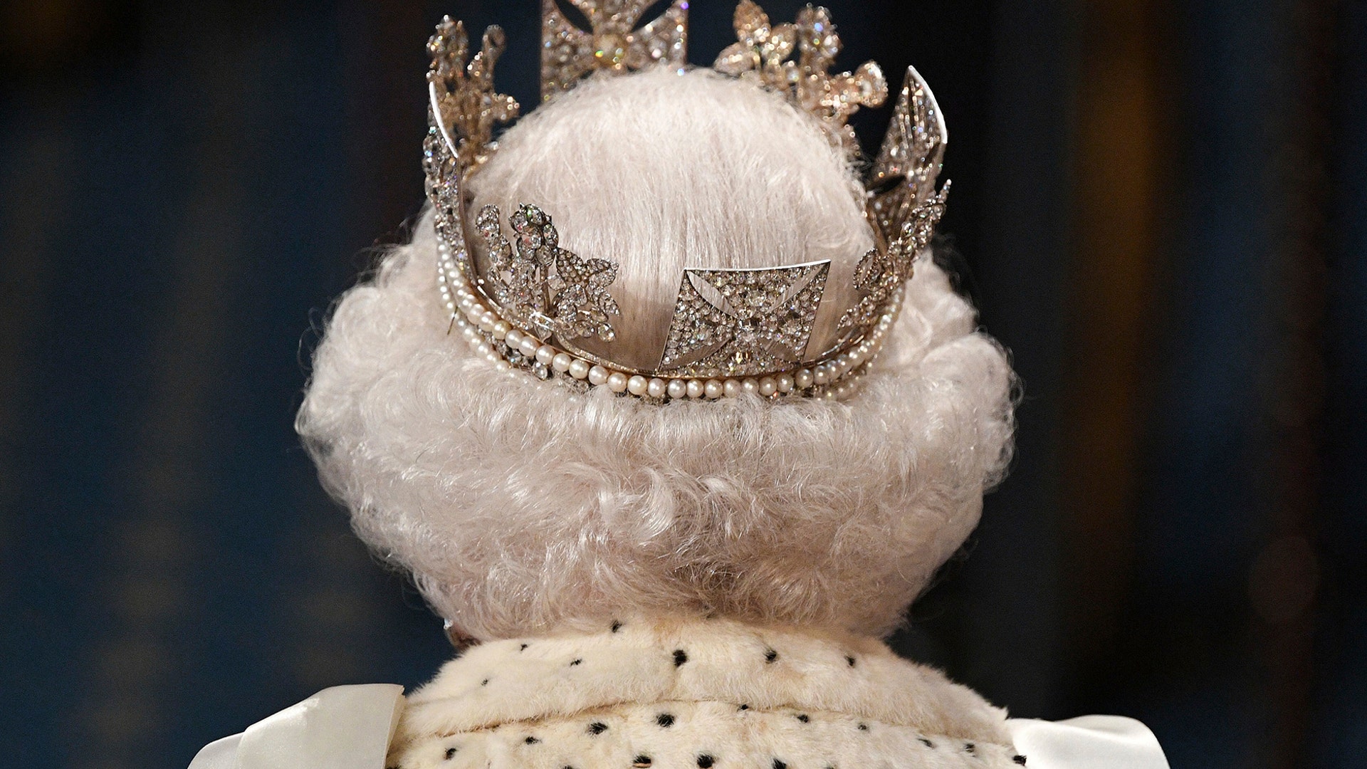 Britain's Queen Elizabeth II proceeds through the Royal Gallery before delivering the Queen's Speech at the State Opening of Parliament in London, Oct. 14, 2019. 