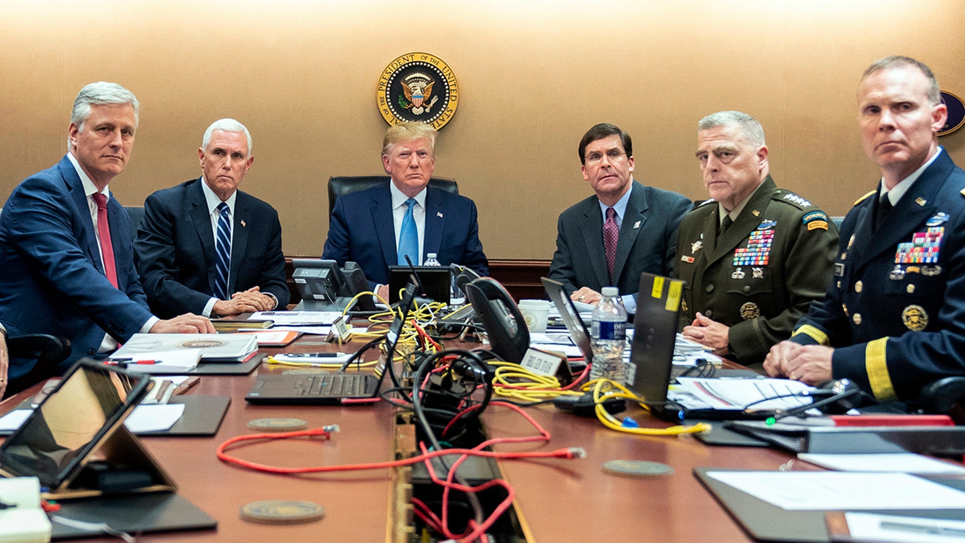 President Donald Trump is joined by from left, national security adviser Robert O'Brien, Vice President Mike Pence, Defense Secretary mark Esper, Joint Chiefs Chairman Gen. Mark Milley and Brig. Gen. Marcus Evans, Deputy Director for Special Operations on the Joint Staff, Saturday, Oct. 26, 2019, in the Situation Room of the White House in Washington. monitoring developments as in the U.S. Special Operations forces raid that took out Islamic State leader Abu Bakr al-Baghdadi. (Shealah Craighead/The White House via AP)