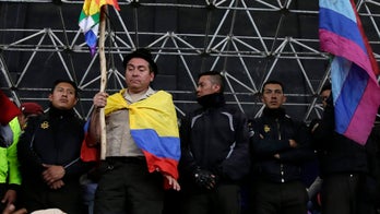 Ecuadorian anti-government protesters show off captive police officers