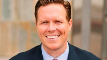 Arizona official charged in adoption scheme is suspended