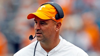 Tennessee's Jeremy Pruitt seen grabbing face mask of quarterback after key fumble
