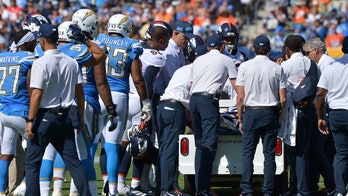 Denver Broncos' De'Vante Bausby leaves field on medical cart after colliding with teammate