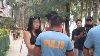 Tourist fined for 'erotic and lewd' bikini only wore it because she lost a bet, boyfriend claims