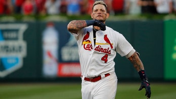 St. Louis Cardinals' Yadier Molina performs throat-slashing gesture after game-winner