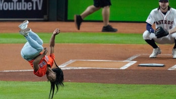 Simone Biles adds flip and twist to her first pitch at Game 2 of World Series