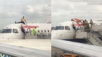 Climate change protester climbs on top of British Airways plane, forces flight delay