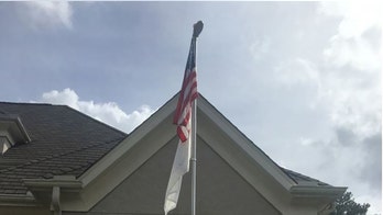 Mother of mass shooting victim says home owners association wants flag honoring son to come down