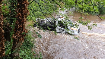 Crews rescue two men and dog after driver follows GPS directions into raging river