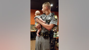 Police officer at Kentucky restaurant holds 'fussy' baby so mom can eat, viral photo shows