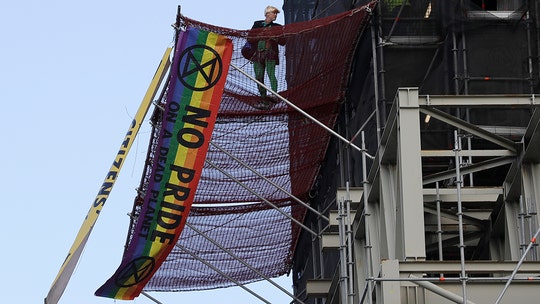 Climate change protester climbs Big Ben dressed as Boris Johnson, drapes banners