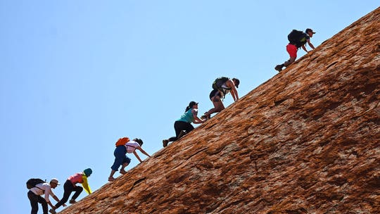 Australia's Uluru scaled by final climbers before ban on sacred site goes into effect