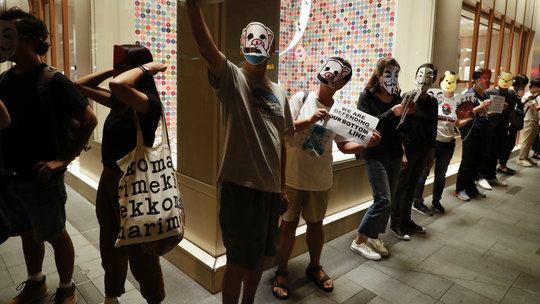 Hong Kong protesters don cartoon masks to defy face mask ban