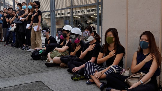 Hong Kong police accused of being 'trigger-happy and nuts' as crowds protest shooting of teen