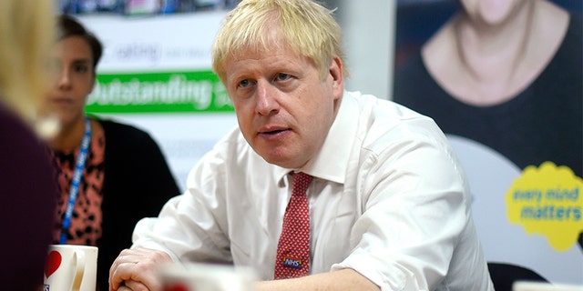 Britain's Prime Minister Boris Johnson speaks to mental health professionals during his visit to Watford General Hospital, in Watford, on Monday. (AP)