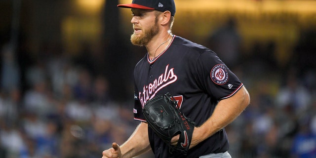 Washington Nationals starting pitcher Stephen Strasburg smiles after the last out in the third inning against the Los Angeles Dodgers in Game 2 of a baseball National League Division Series on Friday, Oct. 4, 2019, in Los Angeles. (Associated Press)