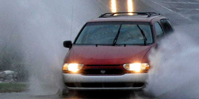 Cars travel along a partially flooded road in Helena, Ala., on Friday, Oct. 25, 2019. The National Weather Service said a disturbance in the Gulf of Mexico that could briefly become a tropical weather system was combining with a cold front to dump heavy rains across the parched region. (Associated Press)