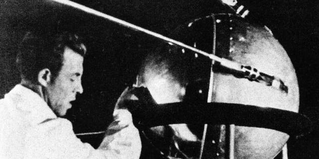 A Soviet technician works on Sputnik 1 before the satellite's Oct. 4, 1957, launch. (NASA)