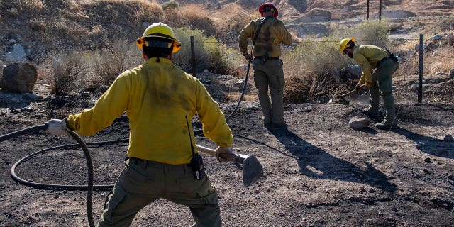 An engine crew looks for any remaining hot spots from the Tick Fire, Oct. 25, 2019, in Santa Clarita, Calif. (Associated Press)