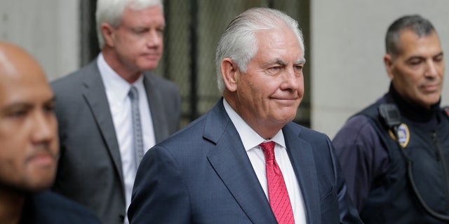 Former Exxon CEO and ex-Secretary of State Rex Tillerson, second from right, leaves a courthouse in New York, Wednesday, Oct. 30, 2019. (AP Photo/Seth Wenig)