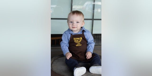 Little Michael seemed to enjoy the experience as he was photographed in the iconic rocking chairs. He even got his own special “Rising Star” apron to wear to mark the occasion.