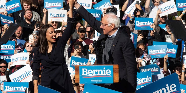 Democratic presidential candidate Sen. Bernie Sanders, I-Vt., right, is introduced by Rep. Alexandria Ocasio-Cortez, D-N.Y., during a campaign rally, Saturday, Oct. 19, 2019, in the Queens borough of New York. (AP Photo/Mary Altaffer)