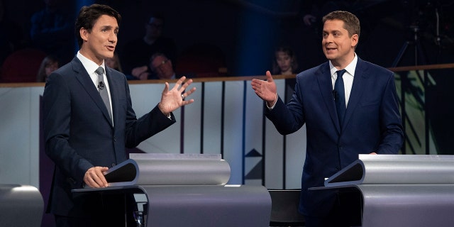 FILE - In this Oct. 10, 2019, file photo, Liberal leader Justin Trudeau and Conservative leader Andrew Scheer take part in the Federal leaders French language debate in Gatineau, Quebec. Polls show that Scheer has a chance to defeat Trudeau's Liberal party in national elections on Monday, Oct. 21. (Adrian Wyld/The Canadian Press via AP)