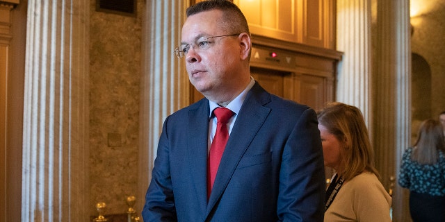 Pastor Andrew Brunson walks from the Senate chamber after giving the Senate opening prayer on Capitol Hill in Washington, Tuesday, Oct. 15, 2019. Brunson flew out of Turkey one year ago after a Turkish court convicted him of terror links but freed him from house arrest he'd already spent nearly two years in detention. (AP Photo/Manuel Balce Ceneta)