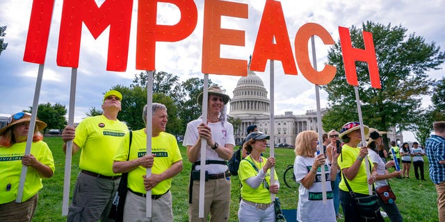 Activists rally for the impeachment of President Donald Trump, at the Capitol in Washington, Thursday, Sept. 26, 2019. Speaker of the House Nancy Pelosi, D-Calif., committed Tuesday to launching a formal impeachment inquiry against Trump. (AP Photo/J. Scott Applewhite)