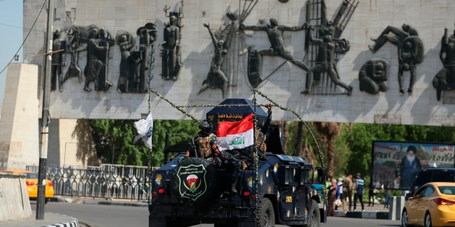 Iraqi security forces arrive near the site of the protests in Tahrir Square in central Baghdad on Saturday. Curfew has been lifted in the capital, days after authorities imposed it in an attempt to quell anti-government demonstrations that have turned deadly. Officials say at least 64 were killed in the four-day protests that have rocked the capital and southern cities. (AP Photo/Hadi Mizban)