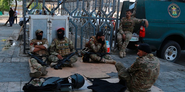 Iraqi riot police deploy Saturday near the site of the protests in Tahrir Square in Baghdad. (AP Photo/Hadi Mizban)