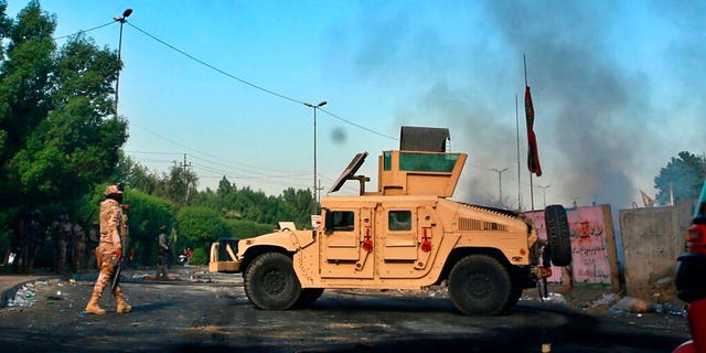 Iraqi Army troops deployed at a site of protests in Baghdad on Sunday. (AP Photo/Khalid Mohammed)