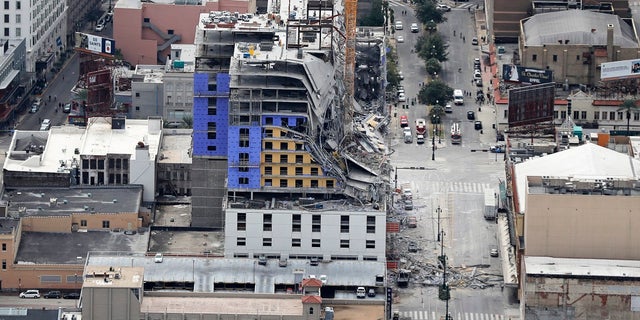 This aerial photo shows the Hard Rock Hotel, which was under construction, after a fatal partial collapse in New Orleans, Saturday. Officials said two damages cranes are hampering rescue efforts to locate a missing worker. (AP Photo/Gerald Herbert)