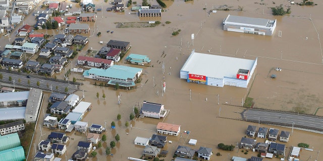 Houses are submerged in muddy waters in Sukagawa, Fukushima prefecture, as Typhoon Hagibis hits the area, northern Japan, Sunday, Oct. 13, 2019. Rescue efforts for people stranded in flooded areas are in full force after a powerful typhoon dashed heavy rainfall and winds through a widespread area of Japan, including Tokyo.(Takuya Inaba/Kyodo News via AP)