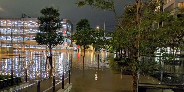 This Oct. 12, 2019 photo by @ar_kaz shows the flooded streets in Kawasaki, near Tokyo, Japan. Helicopters plucked people from their flooded homes on Sunday as rescue efforts went into full force in wide areas of Japan, including Tokyo, after a powerful typhoon unleashed heavy rainfall.(@ar_kaz via AP)