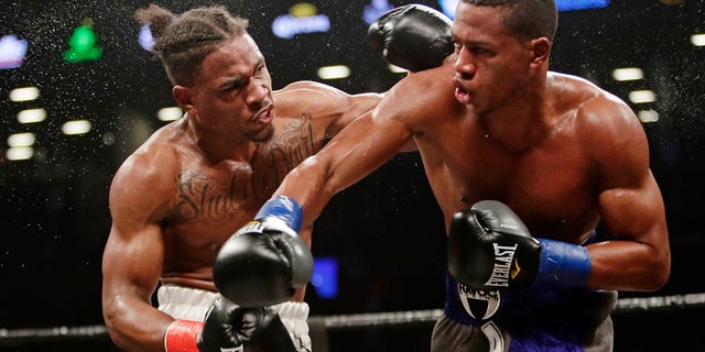 Patrick Day, right, follows through on a right to Kyrone Davis during the fourth round of a March 2018 WBC super welterweight championship boxing match in New York, (AP Photo/Frank Franklin II, File)