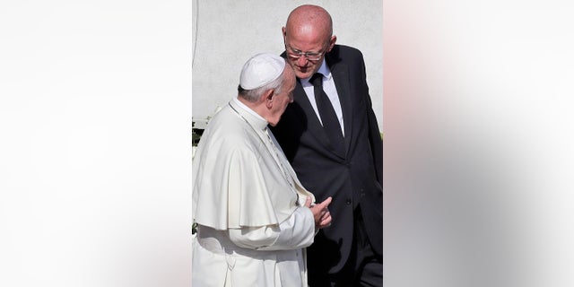 Vatican head of security Domenico Giani, right, shares a word with Pope Francis. (AP Photo/Alessandra Tarantino)