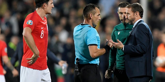 England manager Gareth Southgate, right, speaks with Referee Ivan Bebek during the Euro 2020 group A qualifying soccer match between Bulgaria and England, at the Vasil Levski national stadium, in Sofia, Bulgaria, Monday, Oct. 14, 2019. (AP Photo/Andreea Alexandru)