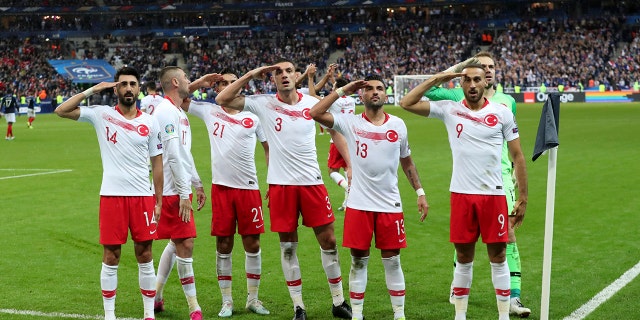 Turkey's players salute as they celebrate a goal against France during the Euro 2020 group H qualifying soccer match between France and Turkey at Stade de France at Saint Denis, north of Paris, France, Monday, Oct. 14, 2019. (AP Photo/Thibault Camus)