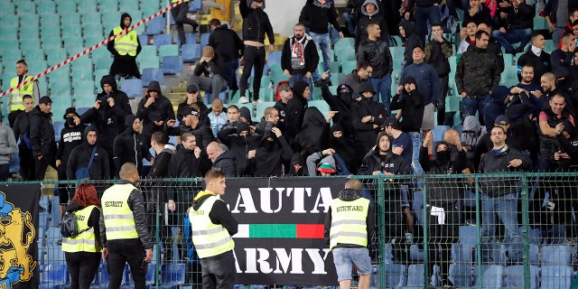 EDS NOTE OBSCENE GESTURES - Bulgarian fans gesture as they stand in the stadium to watch the Euro 2020 group A qualifying soccer match between Bulgaria and England, at the Vasil Levski national stadium, in Sofia, Bulgaria, Monday, Oct. 14, 2019. (AP Photo/Vadim Ghirda)