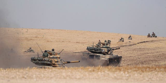 Turkish tanks and troops stationed near Syrian town of Manbij, Syria, Tuesday.
