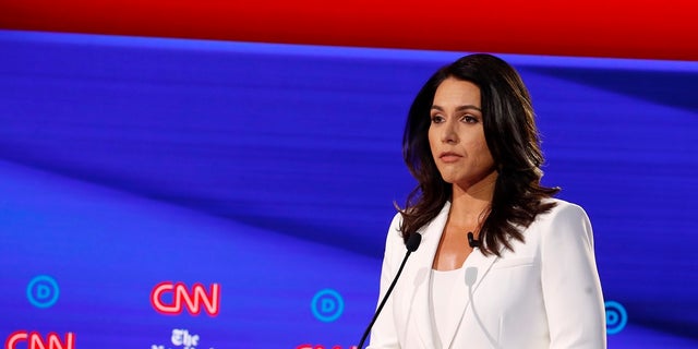 Rep. Tulsi Gabbard listens during a Democratic presidential primary debate hosted by CNN/New York Times at Otterbein University on Oct. 15 in Westerville, Ohio.