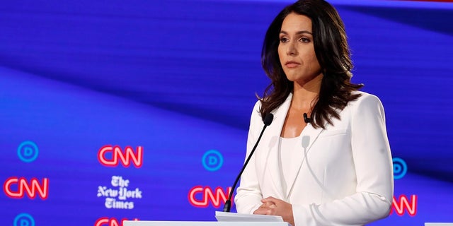 Rep. Tulsi Gabbard listens during a Democratic presidential primary debate hosted by CNN/New York Times at Otterbein University on Oct. 15 in Westerville, Ohio.